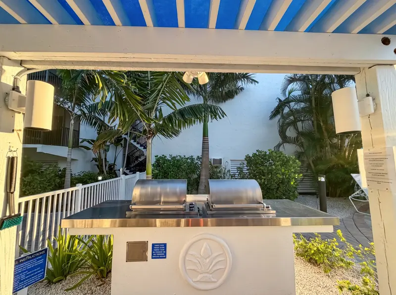 Shaded pool pavilion with outdoor grills