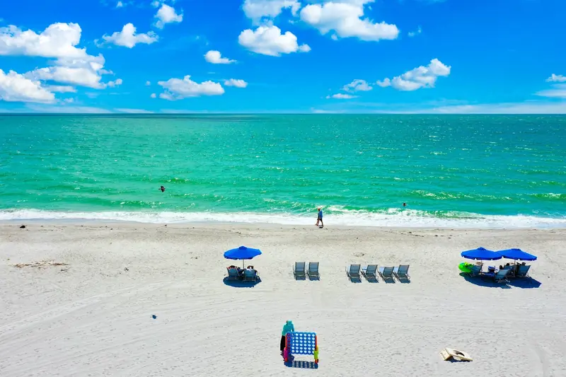 Aerial view of Captiva's white-sand Gulf beach with blue umbrellas
