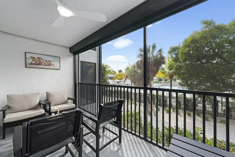 Private screened lanai with seating and tropical views